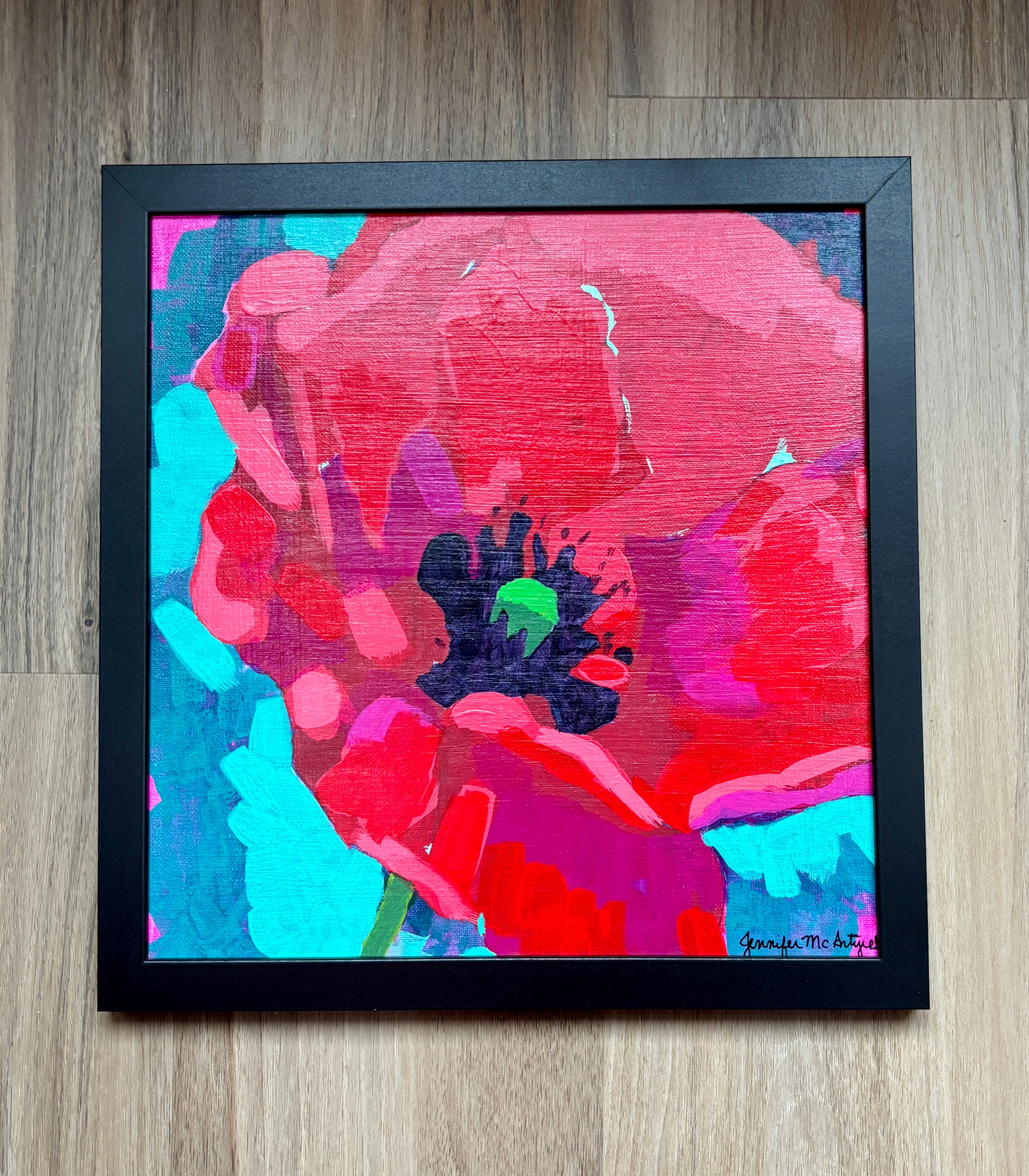 Abstract painting with vibrant colors on a wooden floor