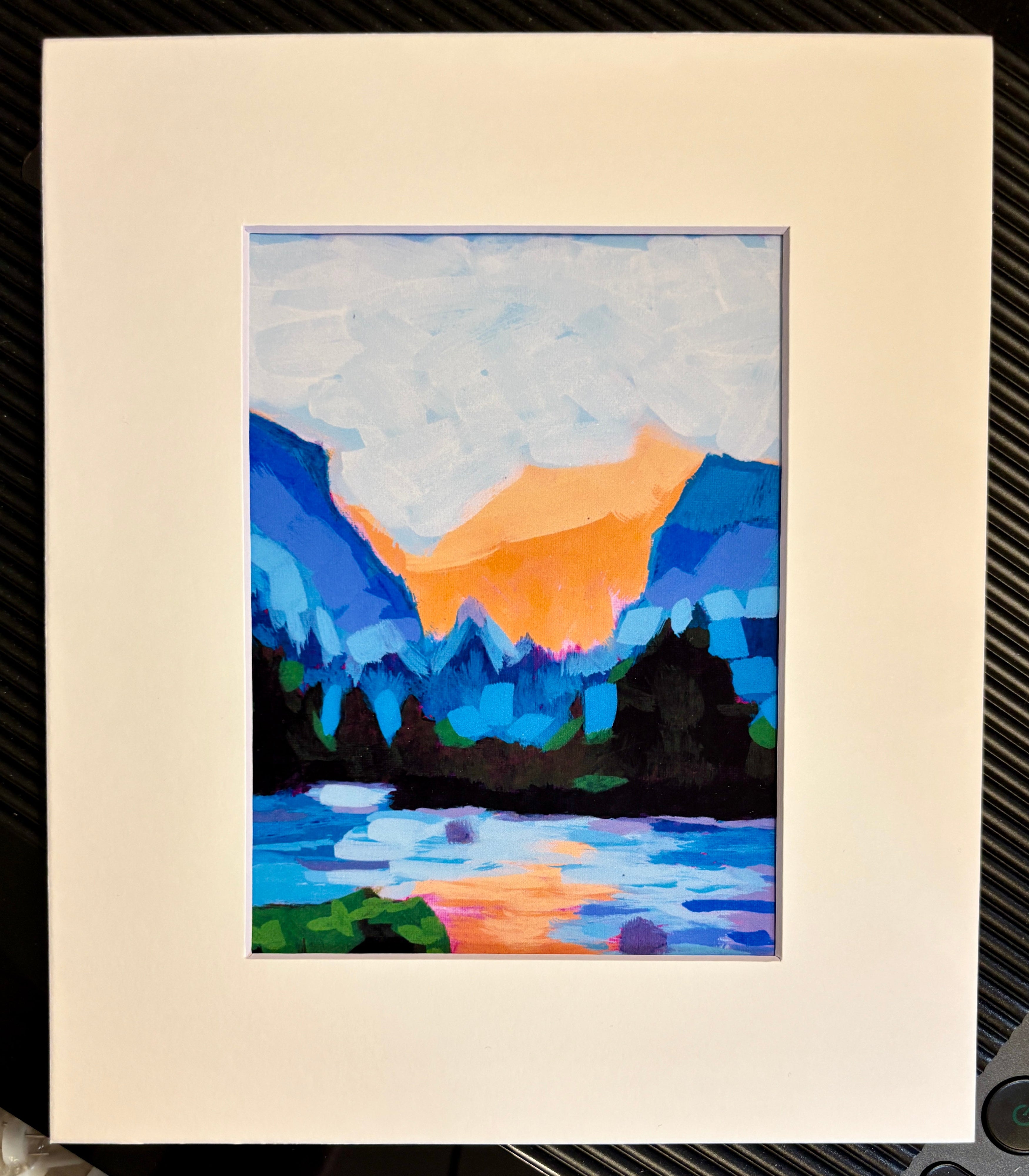 Abstract landscape painting with mountains and water on a white mat.